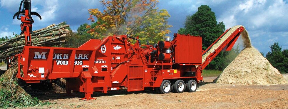 Industrial wood grinder processing brush into mulch